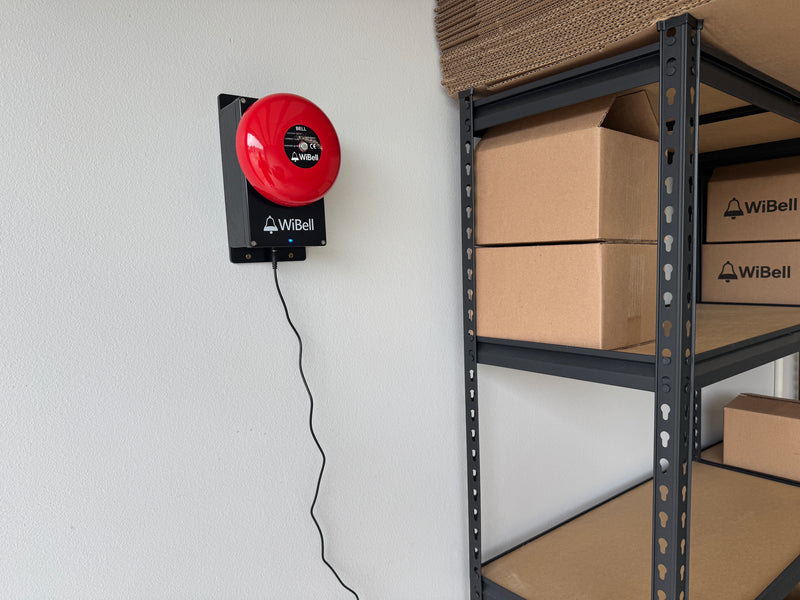 WiBell warehouse shelves stacked with branded shipping boxes - Made in USA