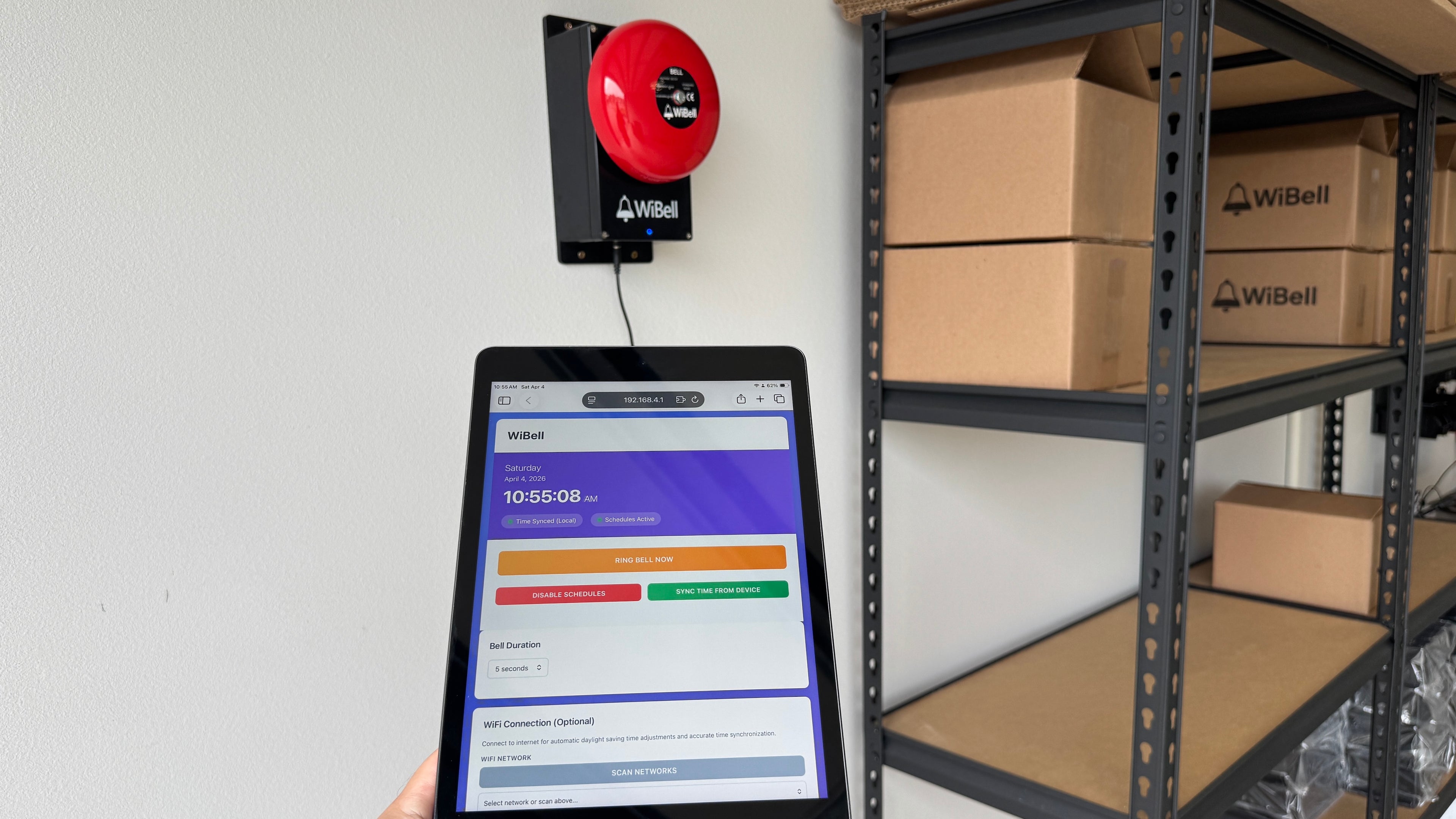WiBell bell on wall with iPad showing schedule control app